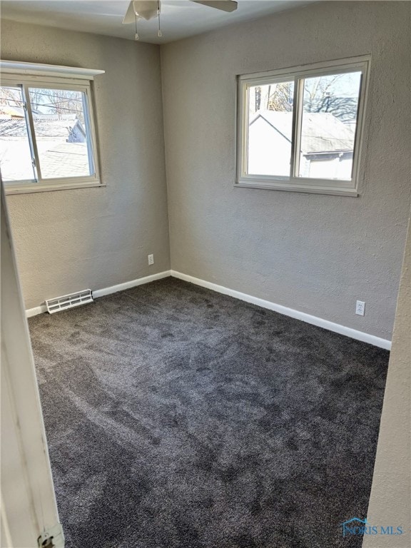 empty room featuring ceiling fan and carpet floors