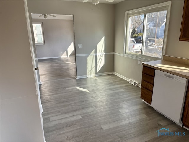 unfurnished dining area featuring ceiling fan and light hardwood / wood-style flooring