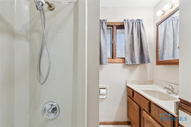 bathroom featuring vanity and a shower