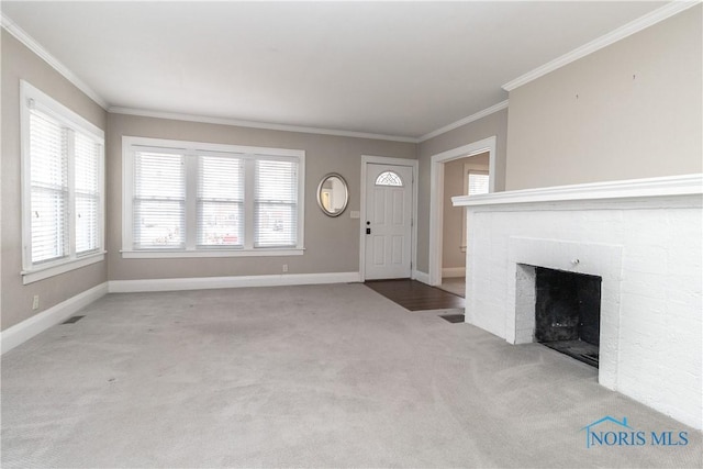 unfurnished living room with ornamental molding and light colored carpet