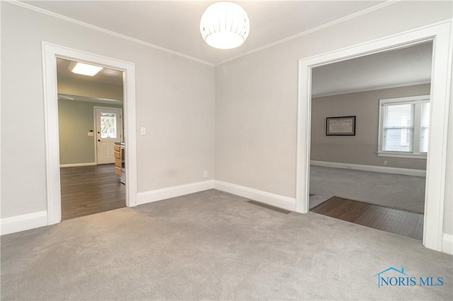 carpeted empty room featuring ornamental molding