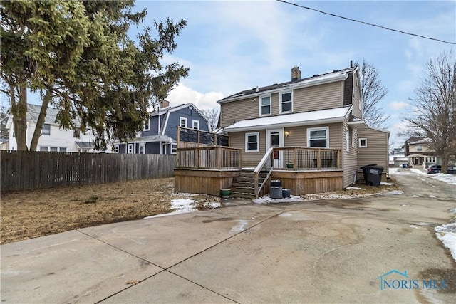 back of property with a wooden deck