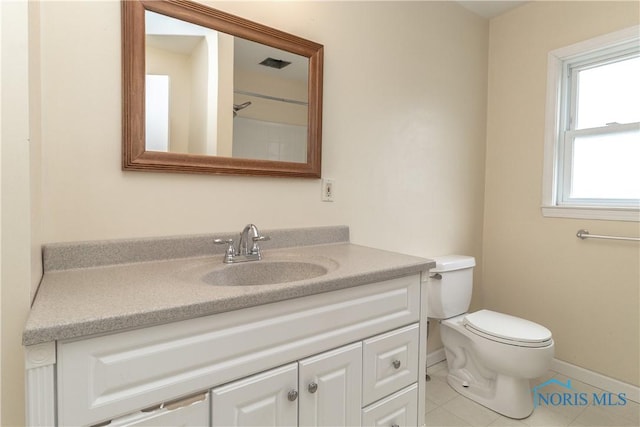 bathroom with tile patterned floors, vanity, and toilet