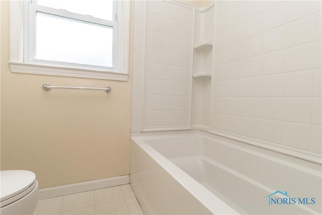 bathroom with tile patterned floors, shower / bathtub combination, and toilet