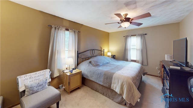 bedroom featuring ceiling fan and light colored carpet