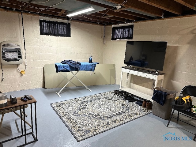 living room with heating unit and concrete flooring