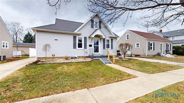 view of front of home with central AC and a front yard