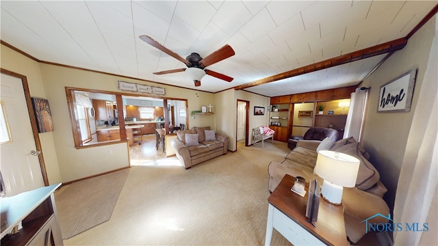 carpeted living room featuring ornamental molding and ceiling fan