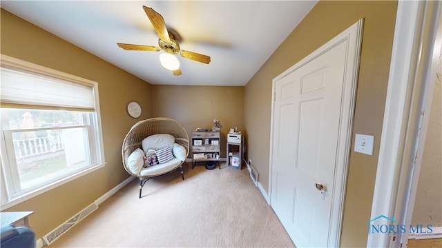 sitting room with light carpet and ceiling fan