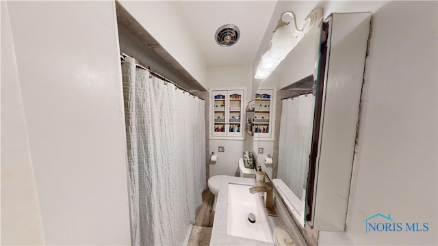 bathroom featuring vanity and toilet