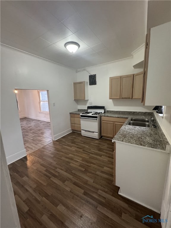 kitchen with dark hardwood / wood-style flooring, light brown cabinetry, sink, and white range with gas stovetop