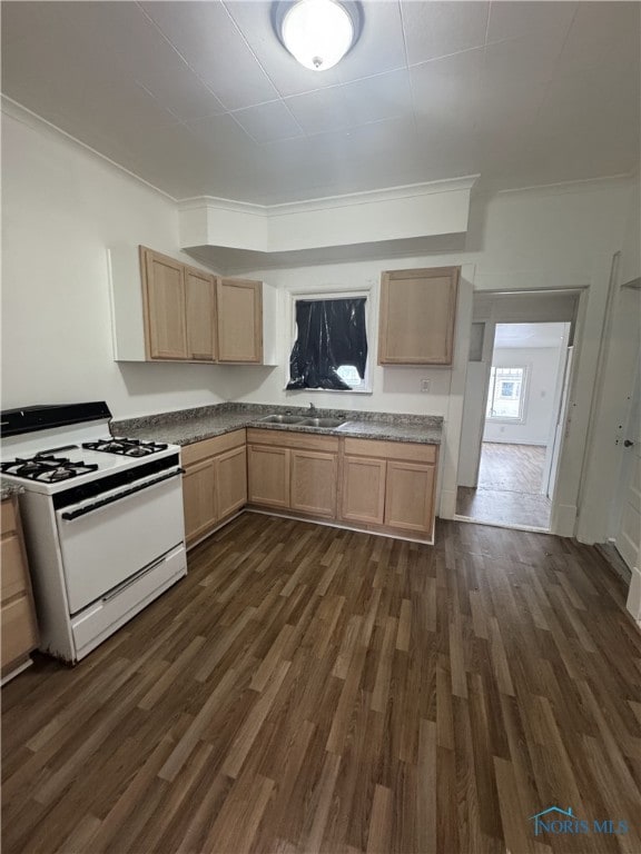 kitchen featuring sink, white range with gas cooktop, and light brown cabinets