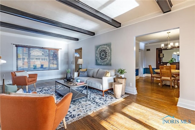 living room featuring beamed ceiling, crown molding, a chandelier, and hardwood / wood-style floors