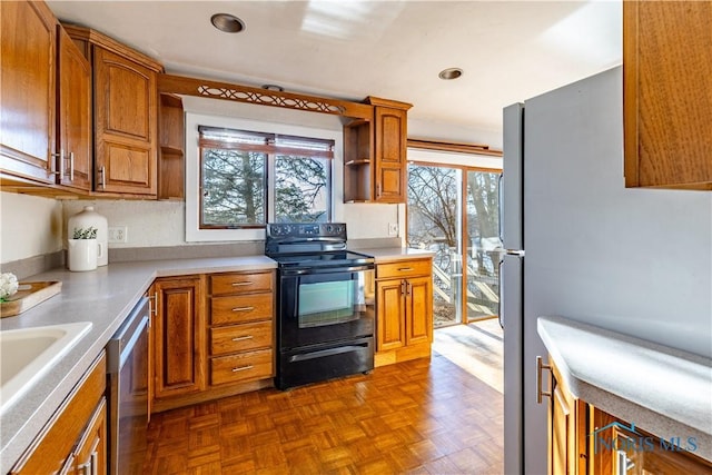 kitchen featuring appliances with stainless steel finishes and dark parquet floors