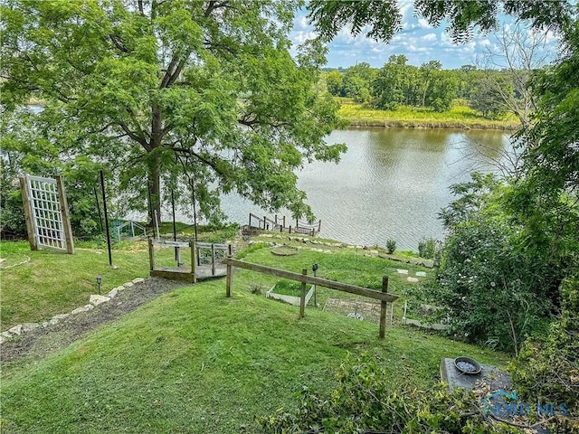 exterior space featuring a lawn and a water view