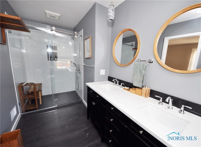 bathroom with vanity, a shower with door, and hardwood / wood-style floors