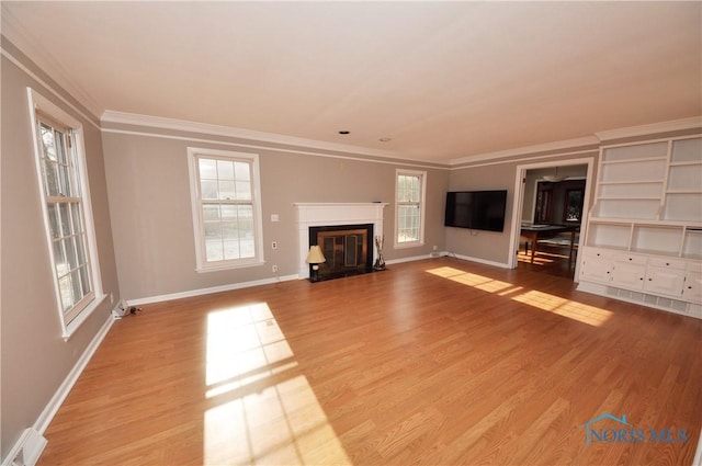 unfurnished living room with ornamental molding and light hardwood / wood-style flooring