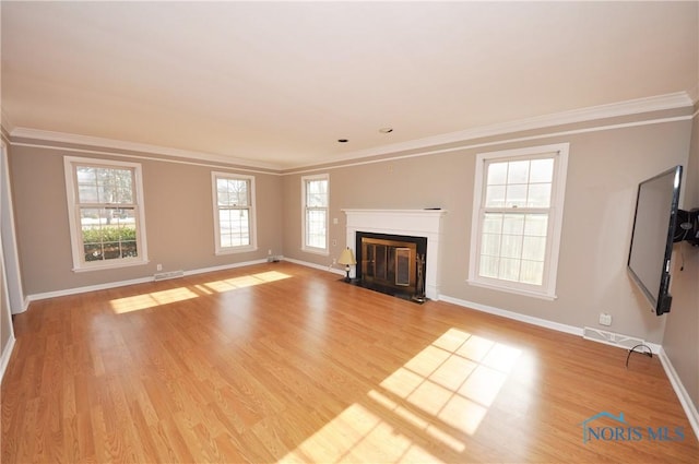 unfurnished living room with crown molding and light wood-type flooring