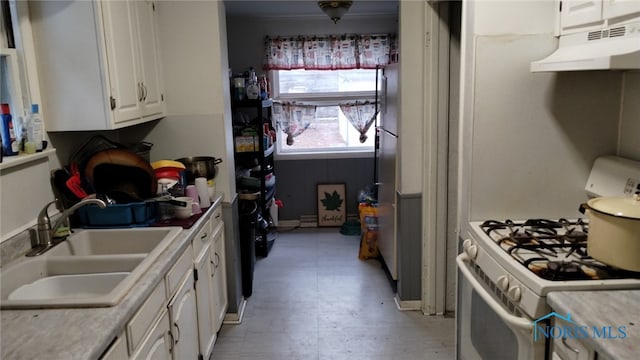 kitchen with white range with gas cooktop, sink, and white cabinetry