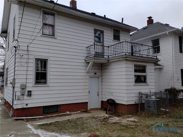 rear view of house with a balcony