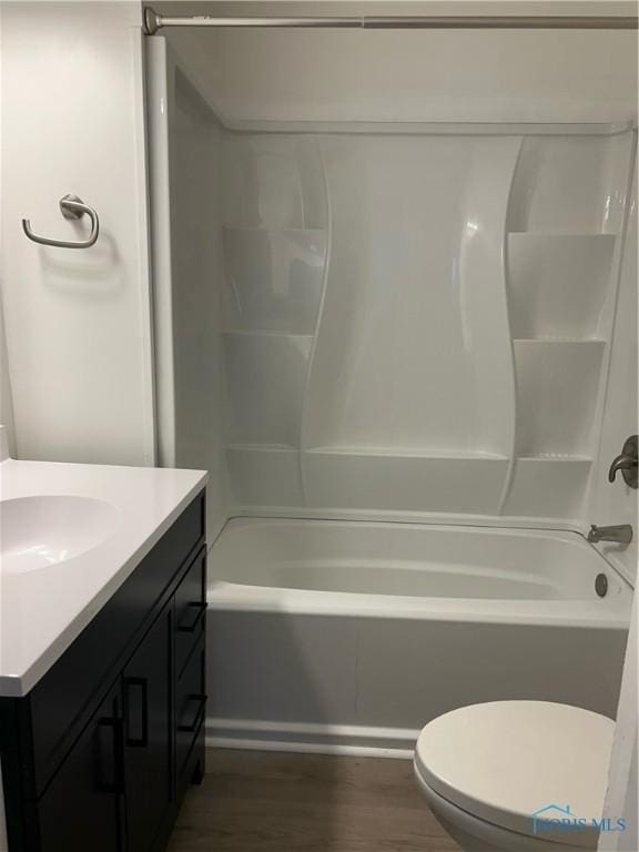 bathroom featuring shower / bath combination, vanity, toilet, and wood finished floors