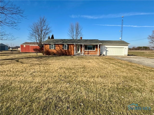 single story home featuring a garage and a front lawn