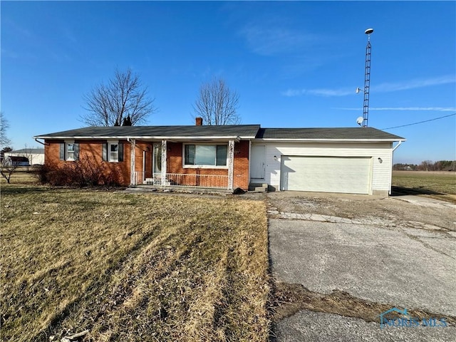 single story home featuring a garage and a front lawn