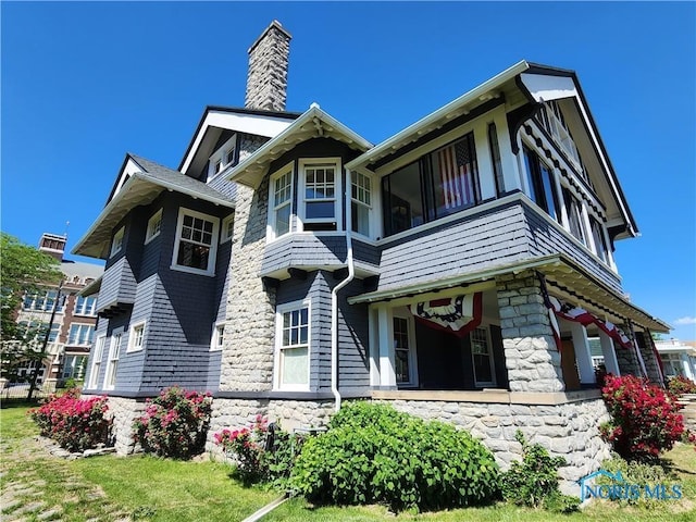 424 Winthrop St, Toledo, OH 43620 - view of front facade featuring stone siding and a chimney