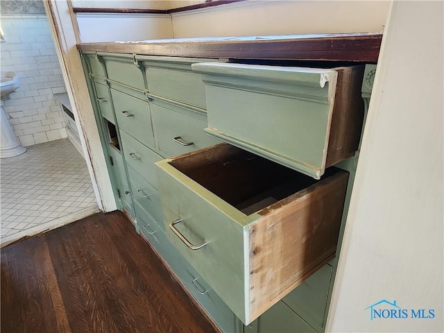 details featuring green cabinetry and dark hardwood / wood-style flooring