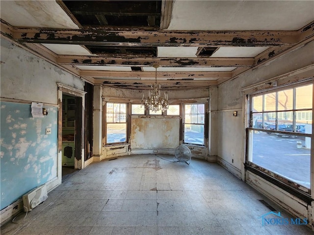 misc room with a notable chandelier and a healthy amount of sunlight