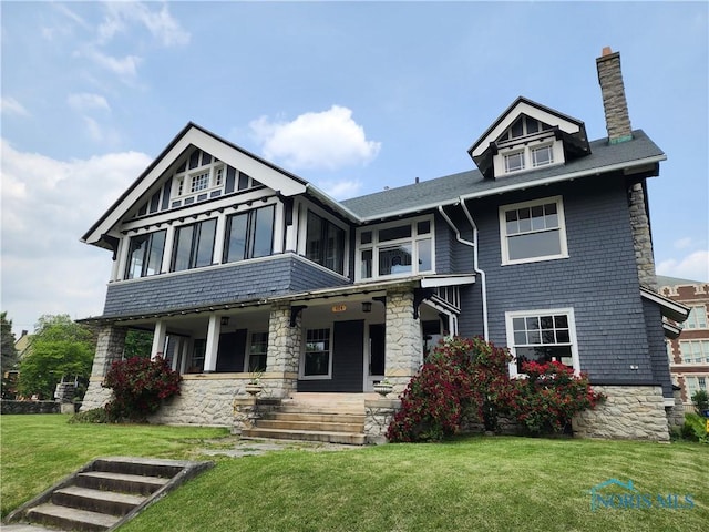 424 Winthrop St, Toledo, OH 43620 - view of front facade with a chimney, covered porch, stone siding, and a front yard