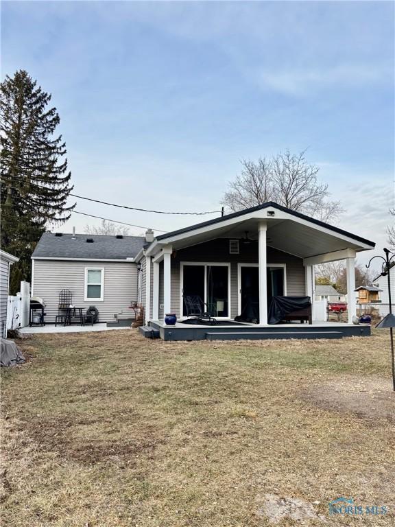 back of house with a yard and a patio area