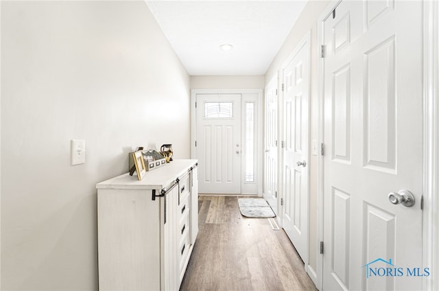 entryway with light wood-style flooring