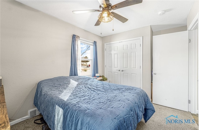 bedroom featuring ceiling fan, a closet, and visible vents