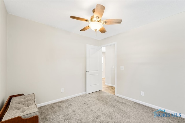 unfurnished bedroom with light carpet, ceiling fan, and baseboards