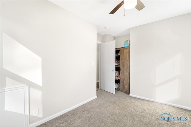 unfurnished bedroom with ceiling fan, baseboards, and light colored carpet