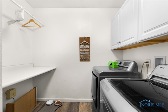 clothes washing area featuring cabinet space, baseboards, dark wood finished floors, and independent washer and dryer