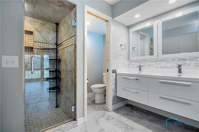 bathroom with walk in shower, vanity, toilet, and tasteful backsplash