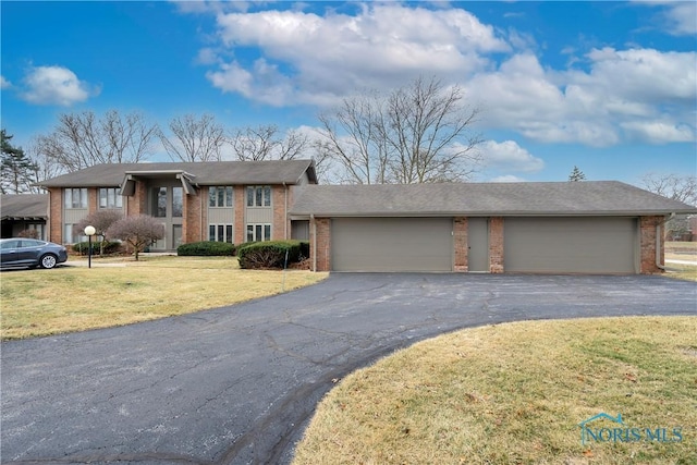 view of front of home with a garage and a front yard