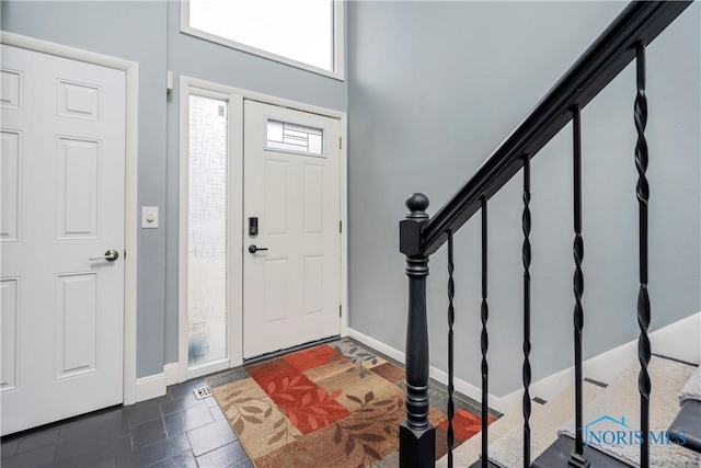 entrance foyer with dark tile patterned flooring