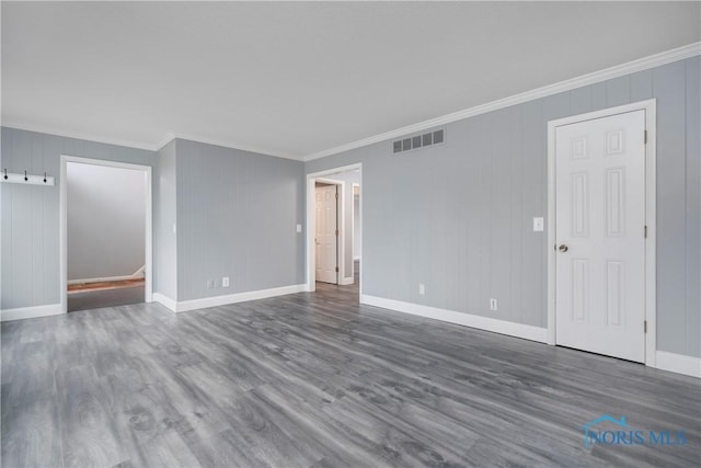 unfurnished room featuring ornamental molding and dark hardwood / wood-style floors