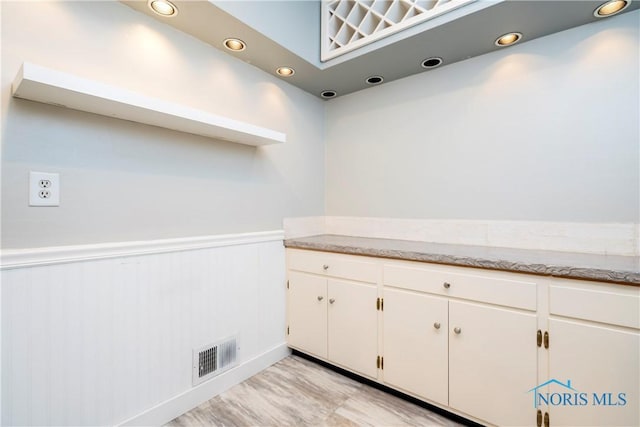 29620 Gleneagles Rd Unit C, Perrysburg, OH 43551 - kitchen featuring white cabinetry, wainscoting, recessed lighting, and light stone counters