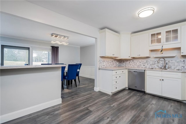 kitchen featuring white cabinetry, sink, stainless steel dishwasher, and dark hardwood / wood-style flooring