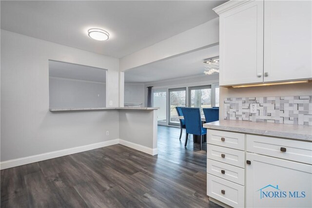 29620 Gleneagles Rd Unit C, Perrysburg, OH 43551 - kitchen with dark wood-style floors, baseboards, white cabinets, light countertops, and backsplash