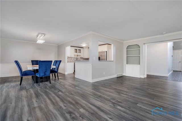 29620 Gleneagles Rd Unit C, Perrysburg, OH 43551 - dining area featuring dark wood-style floors, crown molding, built in shelves, a chandelier, and baseboards