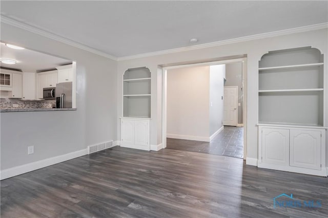 unfurnished dining area featuring crown molding, dark hardwood / wood-style floors, and built in shelves