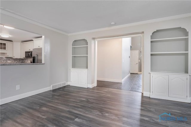 29620 Gleneagles Rd Unit C, Perrysburg, OH 43551 - unfurnished room featuring built in shelves, crown molding, baseboards, and dark wood-type flooring