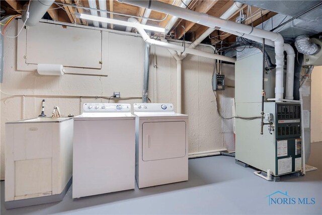 29620 Gleneagles Rd Unit C, Perrysburg, OH 43551 - clothes washing area featuring washing machine and dryer and heating unit