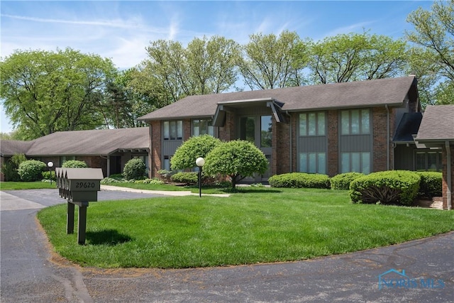 29620 Gleneagles Rd Unit C, Perrysburg, OH 43551 - view of front of property featuring brick siding, a front lawn, and roof with shingles