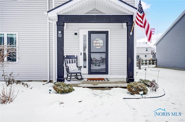 view of snow covered property entrance